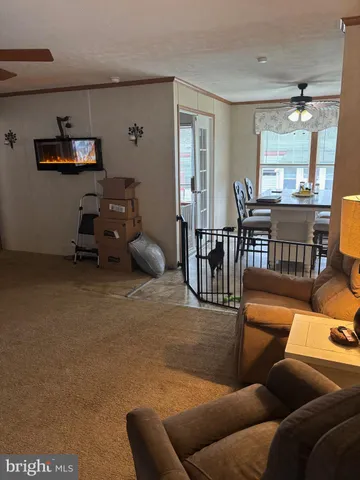 a living room with furniture and a dining table