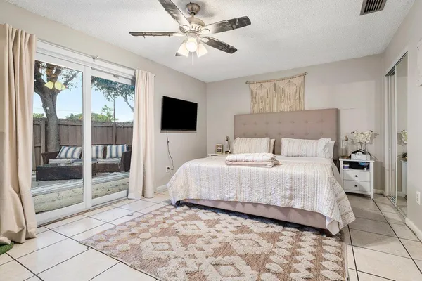a bedroom with a large bed and a flat screen tv