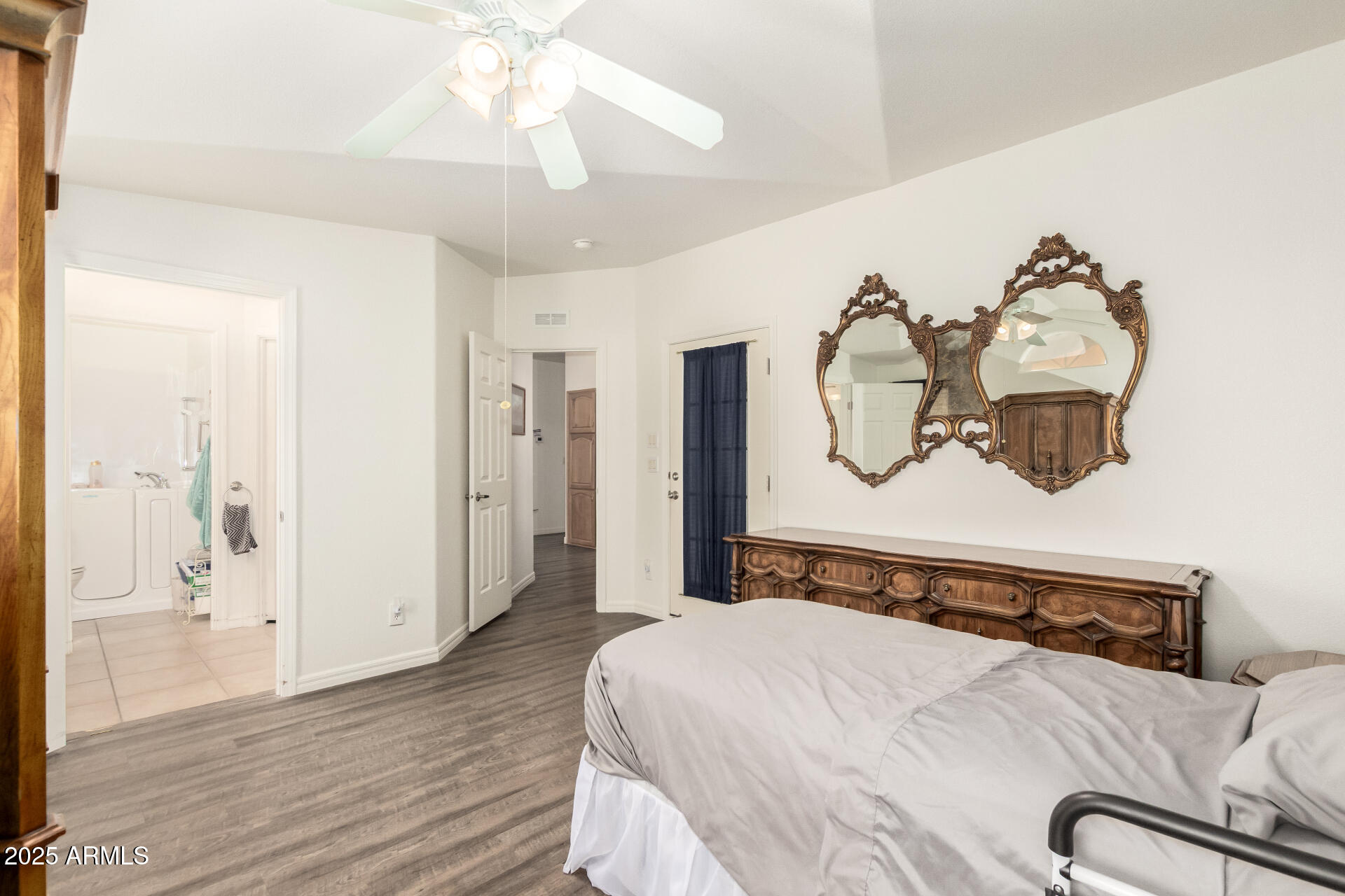 3301 South Goldfield Road, Unit 2097 Apache Junction, AZ 85119 - Photo 12 of 40 a bedroom with a bed and wooden floor