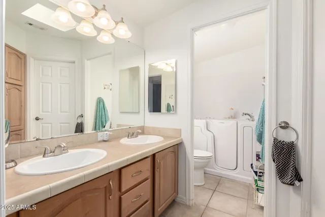 a bathroom with a double vanity sink and a mirror