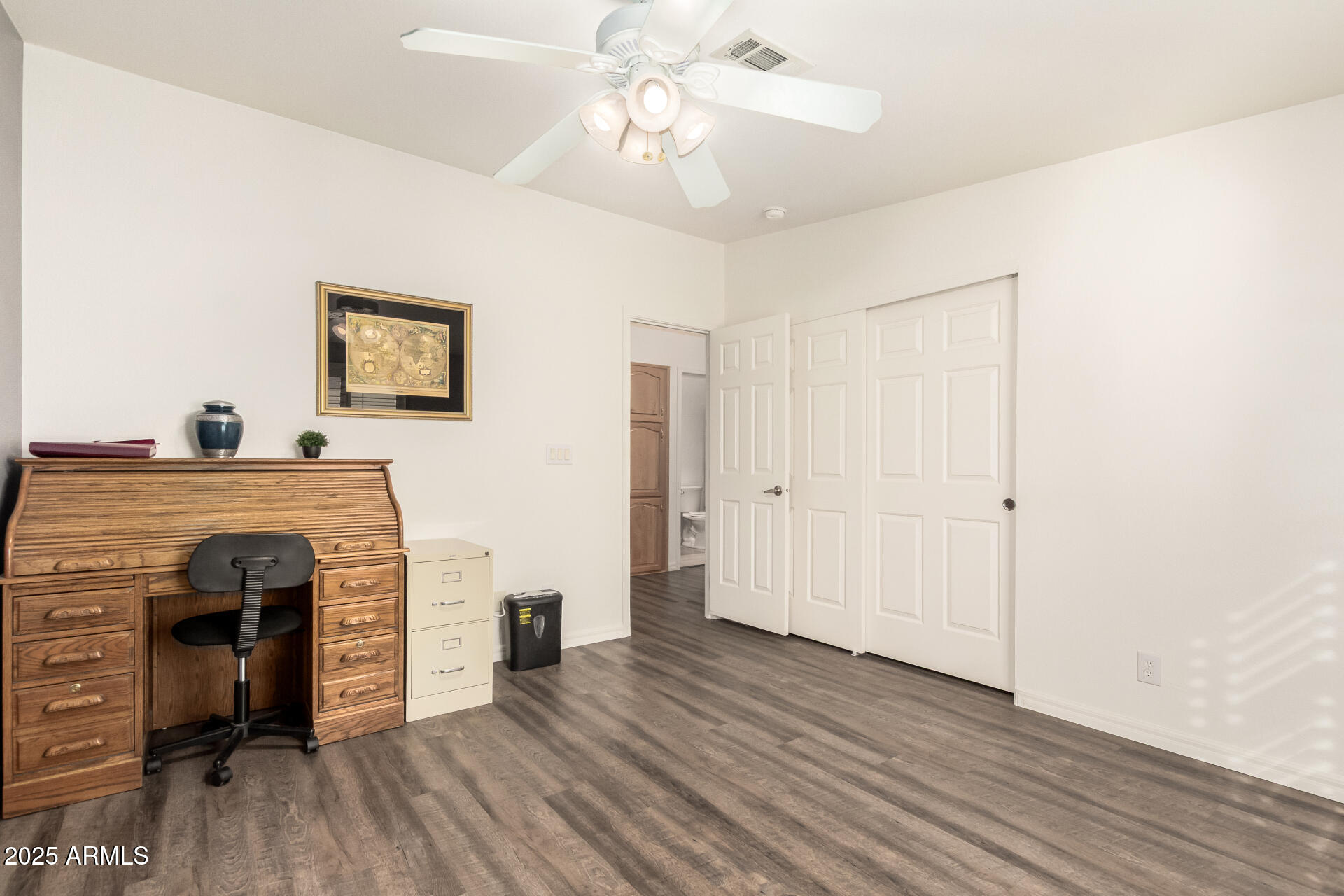 3301 South Goldfield Road, Unit 2097 Apache Junction, AZ 85119 - Photo 15 of 40 a view of a livingroom with a fireplace a ceiling fan and wooden floor