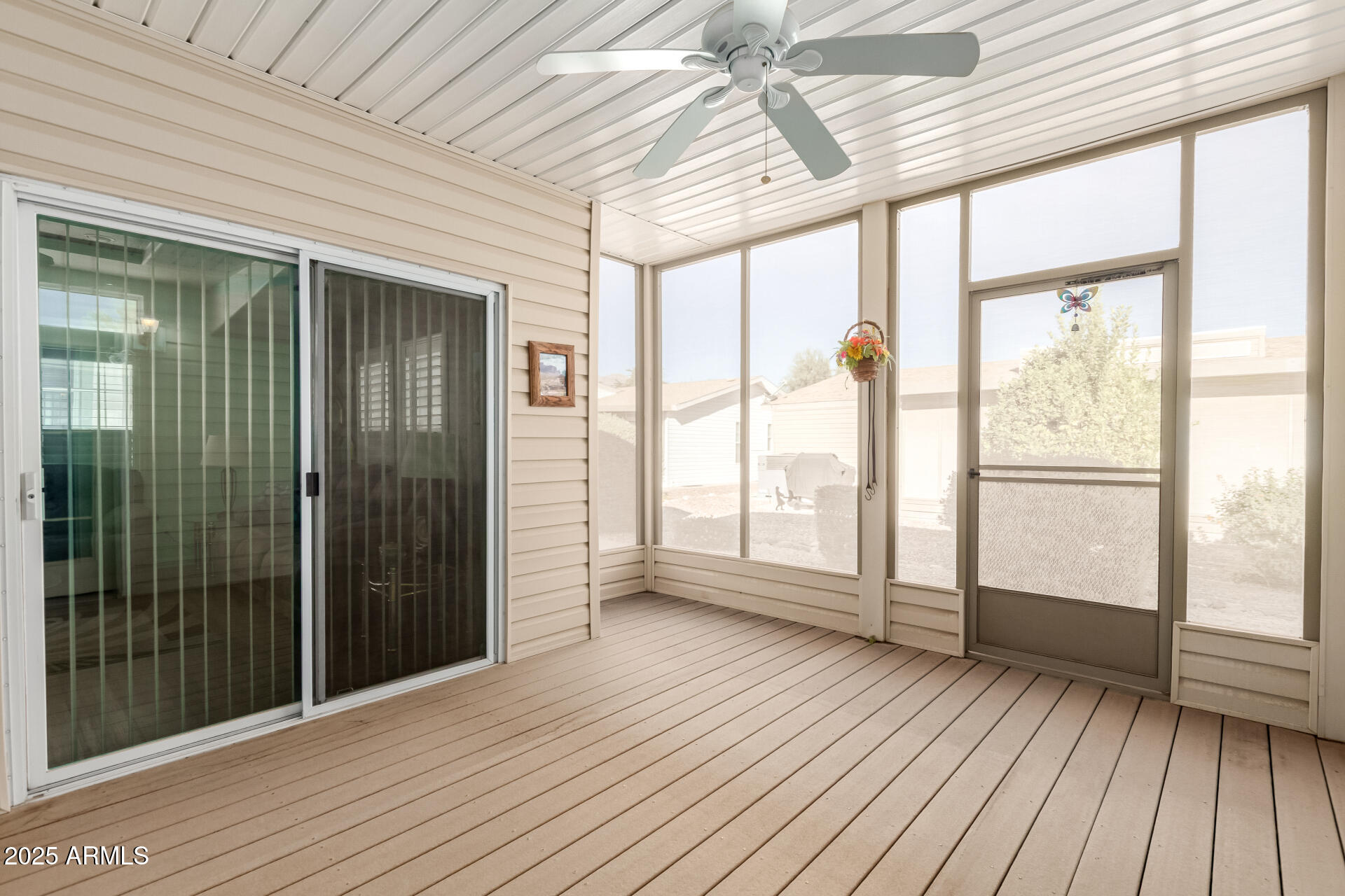 3301 South Goldfield Road, Unit 2097 Apache Junction, AZ 85119 - Photo 19 of 40 a view of an empty room with wooden floor and a window