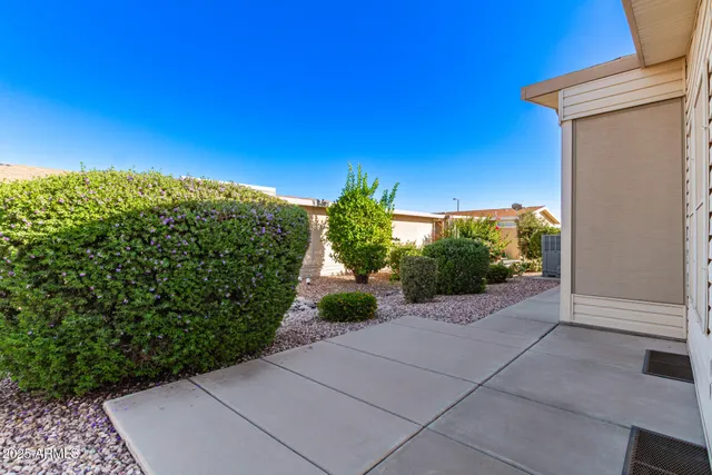 a view of a pathway both side of a house