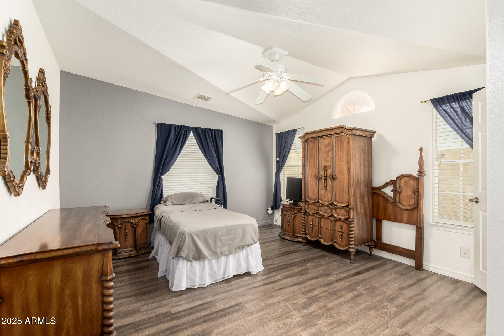 3301 South Goldfield Road, Unit 2097 Apache Junction, AZ 85119 - Photo 5 of 40 a bedroom with a bed and wooden floor