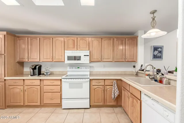 a kitchen with a sink cabinets and window