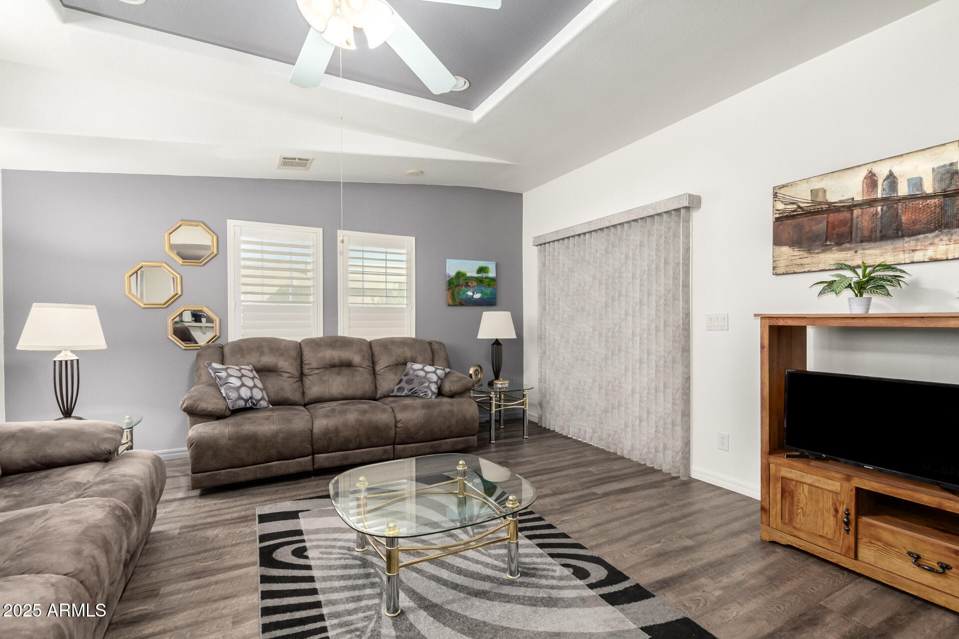 3301 South Goldfield Road, Unit 2097 Apache Junction, AZ 85119 - Photo 10 of 40 a living room with furniture a flat screen tv and a window
