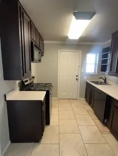 a kitchen with a sink stove and cabinets