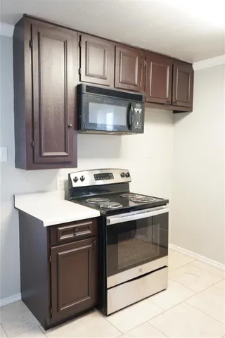 a kitchen with stainless steel appliances granite countertop a stove microwave and sink