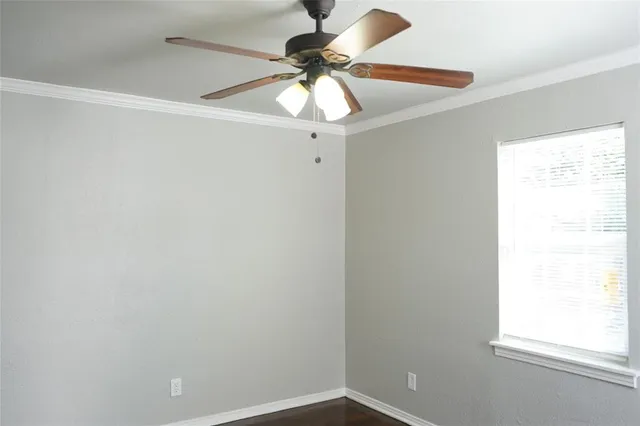 a room with a window and a fan