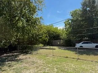 a view of a swimming pool with a yard