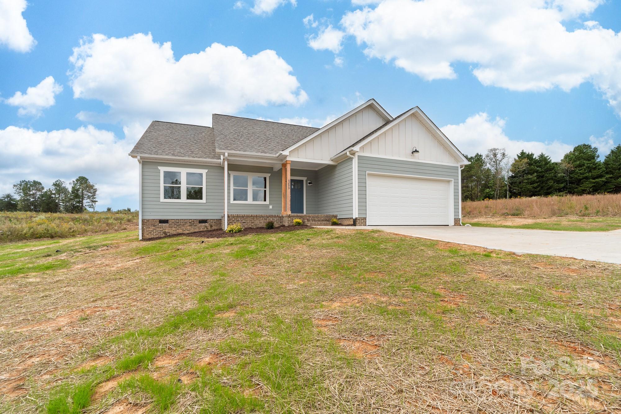 6203 Flay Road Cherryville, NC 28021 - Photo 2 of 34 a view of a house with a yard and potted plants