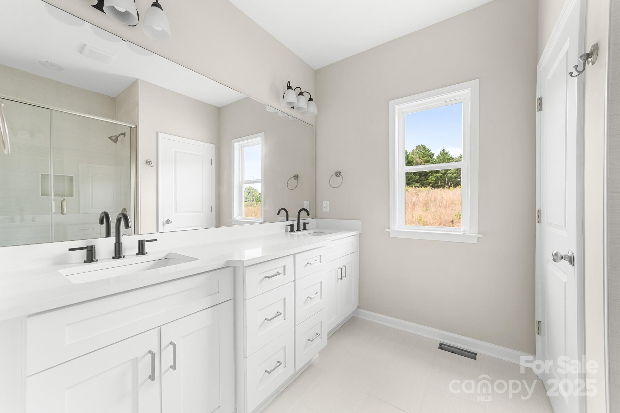 6203 Flay Road Cherryville, NC 28021 - Photo 25 of 34 a spacious bathroom with double sink and a mirror