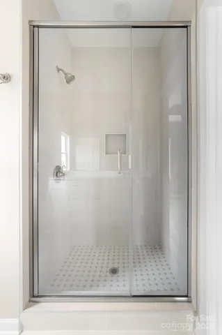 a bathroom with a glass shower door