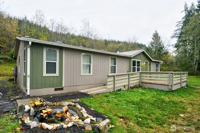 a backyard of a house with table and chairs