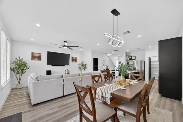 a kitchen with stainless steel appliances a refrigerator a sink and wooden floor