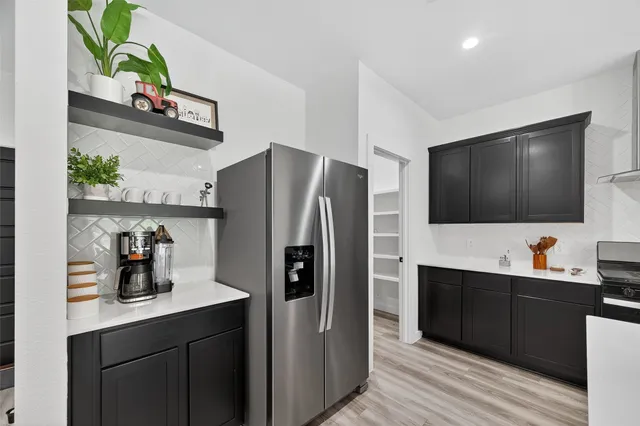 a kitchen with stainless steel appliances a sink stove and refrigerator