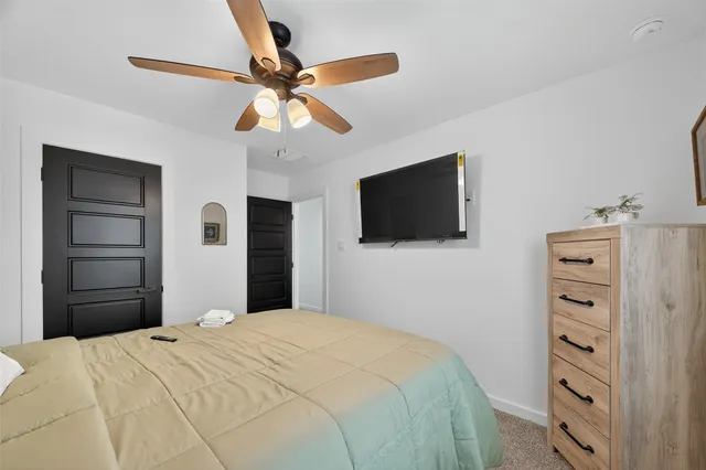 a bedroom with a bed and a flat screen tv