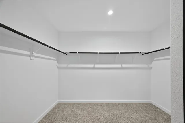 a spacious bathroom with a double vanity sink a mirror and shower