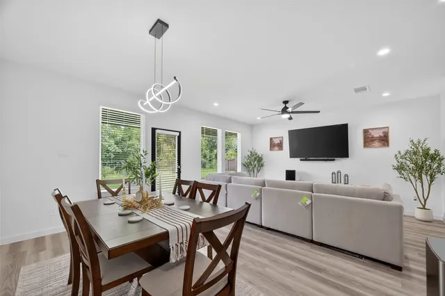 a view of a dining room with furniture wooden floor and a chandelier