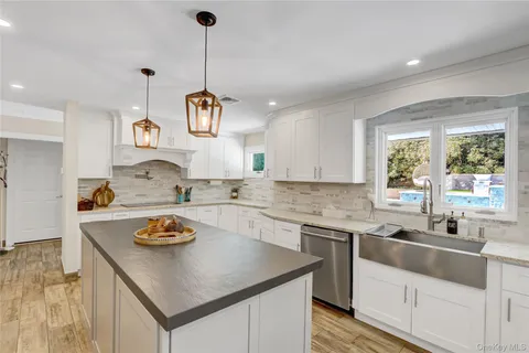 a kitchen with a sink a stove and cabinets