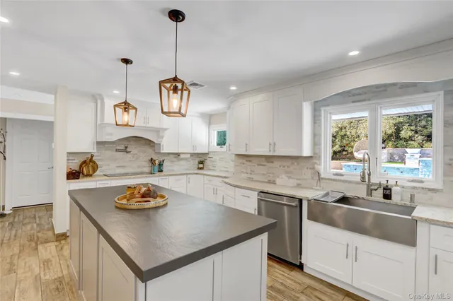 a kitchen with a sink a stove and cabinets
