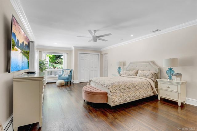 a bedroom with a bed couch and a window