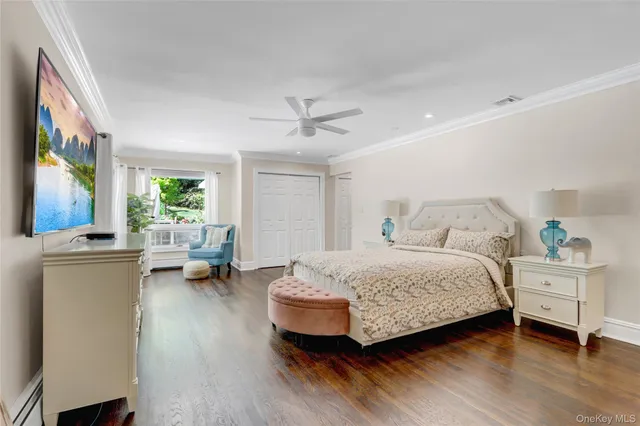 a bedroom with a bed couch and a window