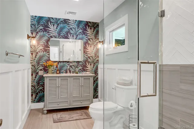 a bathroom with a toilet and shower