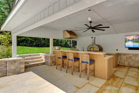 a view of a patio with a table and chairs
