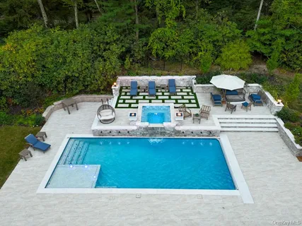 swimming pool view with a seating space