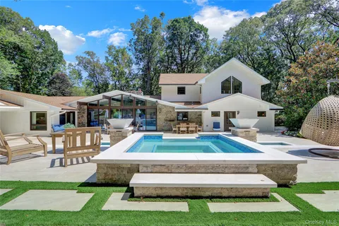 a front view of a house with a yard table and chairs