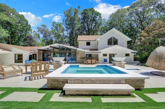 a front view of a house with a yard table and chairs