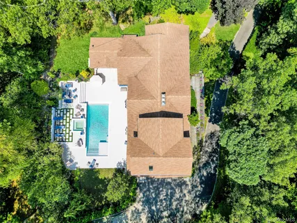 an aerial view of a house with a yard and garden