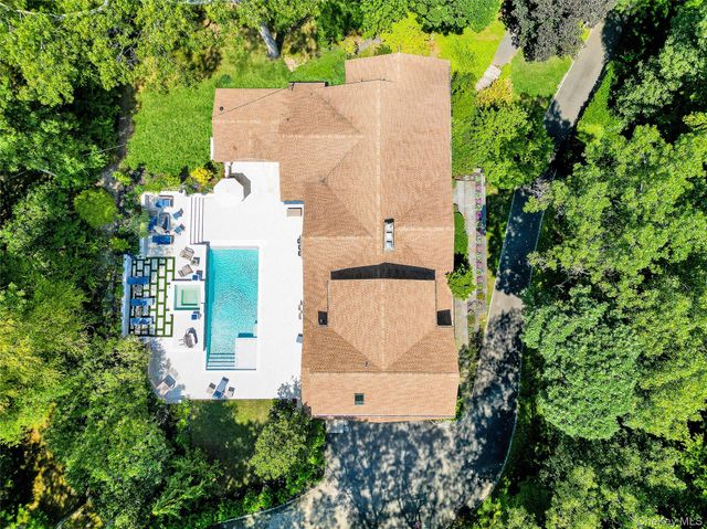 an aerial view of a house with a yard and garden