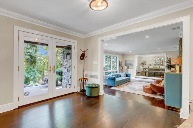 a view of a living room and floor to ceiling window wooden floor