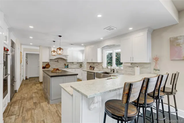 a kitchen with stainless steel appliances kitchen island granite countertop a sink and cabinets