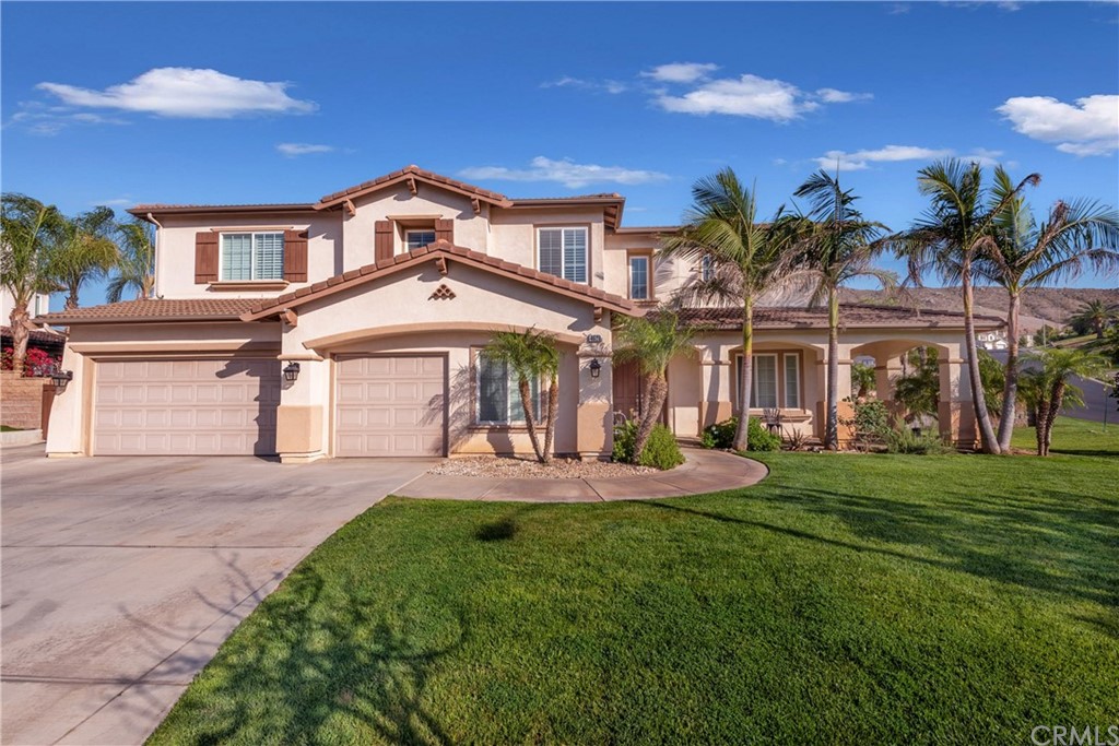 4628 Ridge Point Way Jurupa Valley, CA 92509 - Photo 1 of 1 a front view of a house with a yard and potted plants