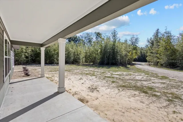 a view of a porch with a floor to ceiling window