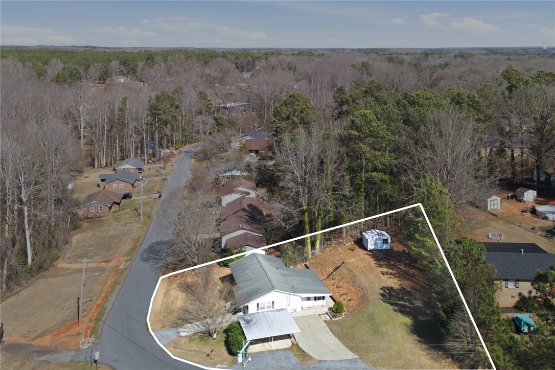 108 Hodge Street Abbeville, SC 29620 - Photo 32 of 39 Perched on a verdant hillside, this property offers serene, tree-lined views and a comfortable home.