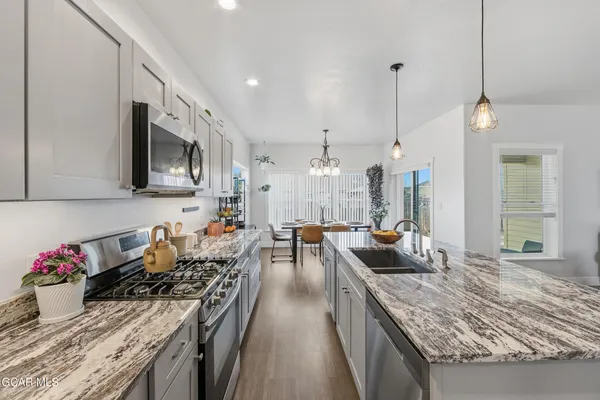 a en suite bathroom with a granite countertop double vanity sink and a mirror