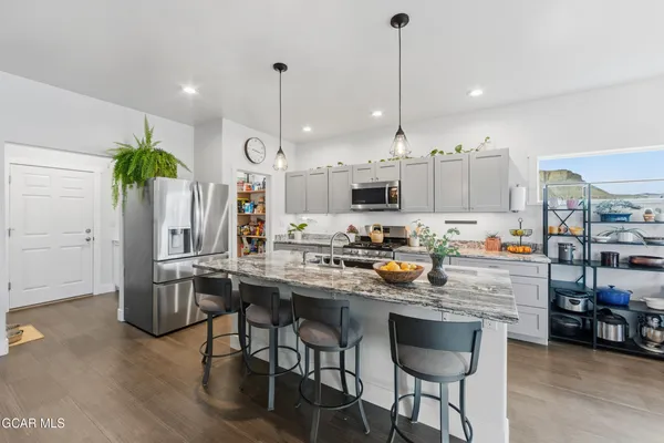 a bathroom with a granite countertop toilet sink and mirror