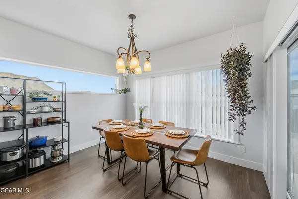 a view of a dining room with furniture and chandelier