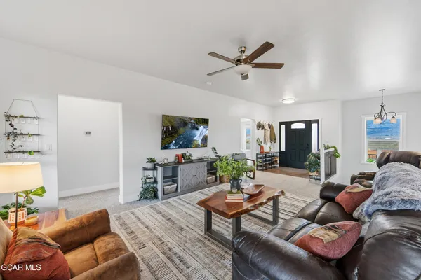 a view of staircase with lots of frames on wall and a chandelier