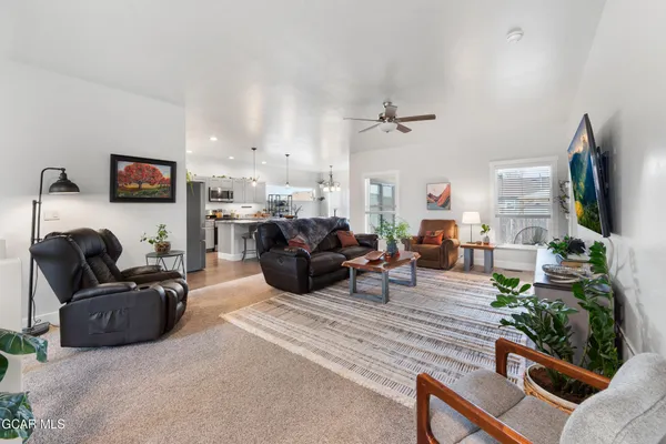a living room with furniture and a chandelier