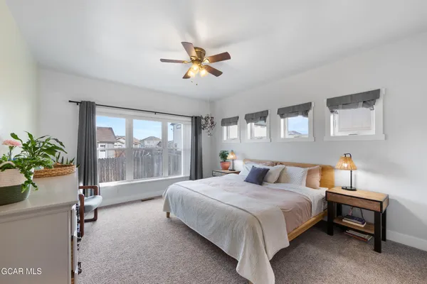 a bedroom with a balcony a bed and a chandelier