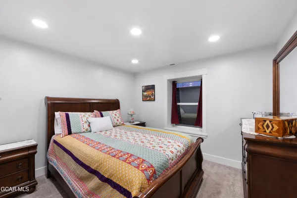 a bedroom with a bed and dresser