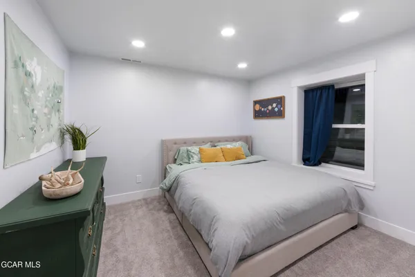 a kitchen with stainless steel appliances granite countertop a sink a stove a refrigerator and chairs