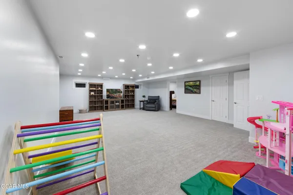 a view of a dining room and livingroom with furniture wooden floor a chandelier