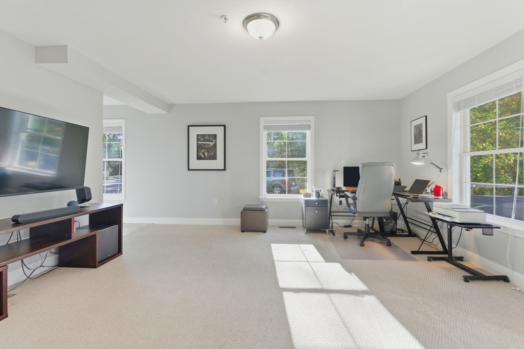 66 Compass Point, Unit 66 North Andover, MA 01845 - Photo 10 of 42 a living room with furniture gym equipment and a window