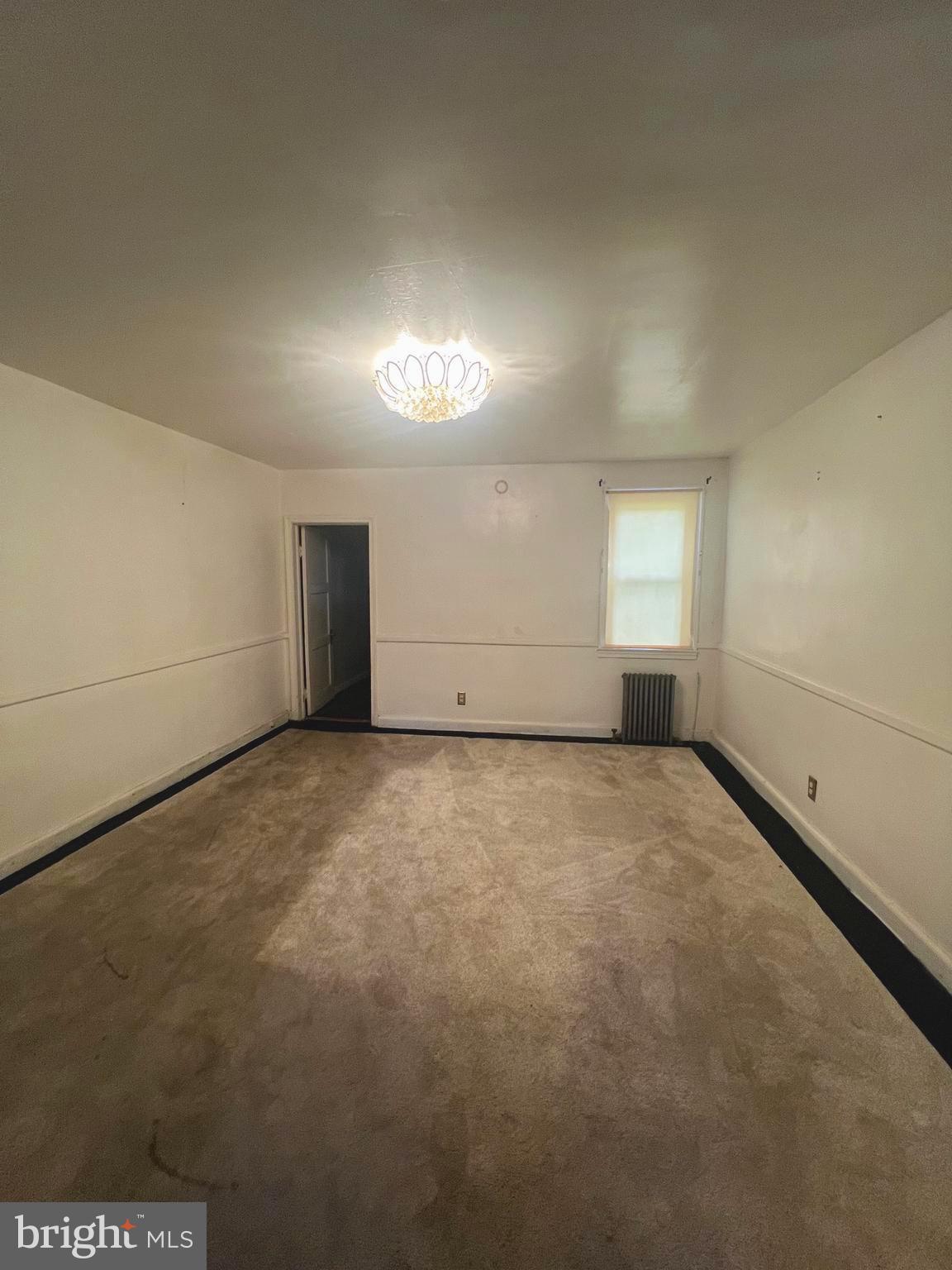 3716 Flowerton Road Baltimore, MD 21229 - Photo 3 of 12 an empty room with a empty space and windows